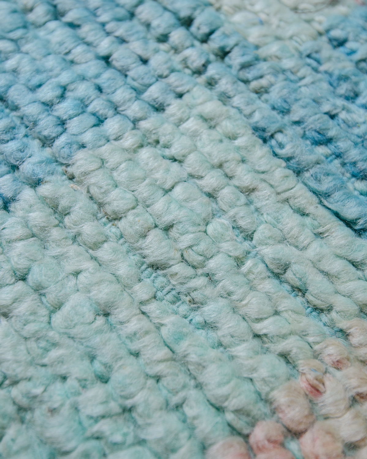 Detail of worn wool on vintage rug.